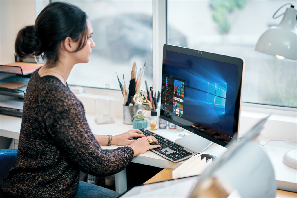 A Woman Sitting in front of a Computer