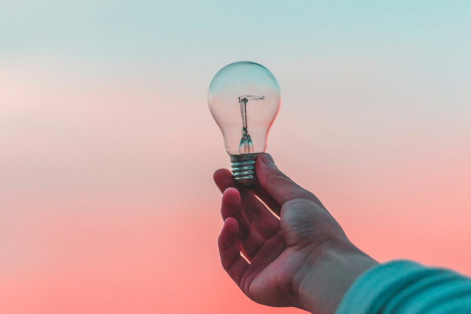 A hand holding a lightbulb